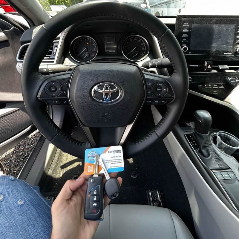 Automotive locksmith working on a car in Atlanta